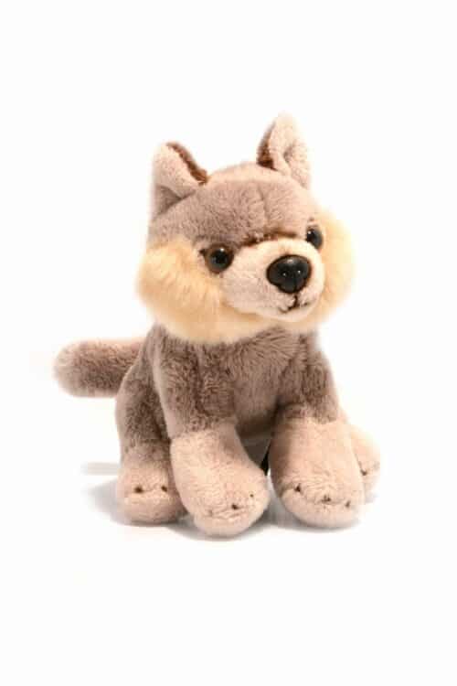 Wild Ireland - A soft, plush toy wolf with light brown fur, darker brown ears, and round black eyes. The wolf sits upright against a plain white background, displaying its stuffed paws and fluffy tail.