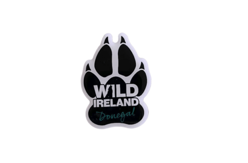 Wild Ireland - The Wild Ireland Paw Print Pin Badge features a black animal paw shape with a white outline. Inside, the text Wild Ireland Donegal is displayed in white and teal on a white background.