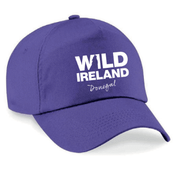 Wild Ireland - A bright pink baseball cap with WILD IRELAND in bold white capitals and Donegal in cursive below.